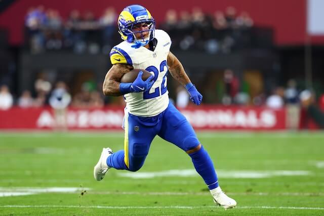 Dec 7, 2025; Glendale, Arizona, USA; Los Angeles Rams running back Blake Corum (22) rushes the ball against the Arizona Cardinals during the first half at State Farm Stadium. Mandatory Credit: Mark J. Rebilas-Imagn Images Blake Corum, Rams