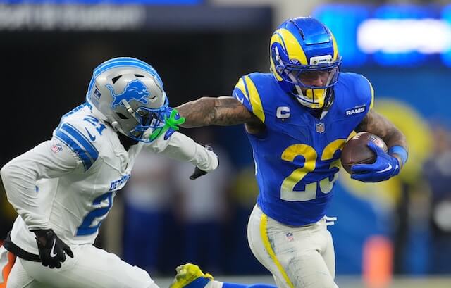 Dec 14, 2025; Inglewood, California, USA; Los Angeles Rams running back Kyren Williams (23) runs the ball against Detroit Lions cornerback Amik Robertson (21) during the fourth quarter at SoFi Stadium. Mandatory Credit: Kirby Lee-Imagn Images Kyren Williams
